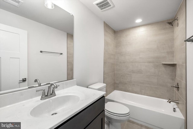 full bathroom featuring toilet, vanity, and tiled shower / bath combo