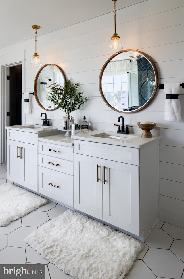 bathroom with two vanities, a sink, and tile patterned floors