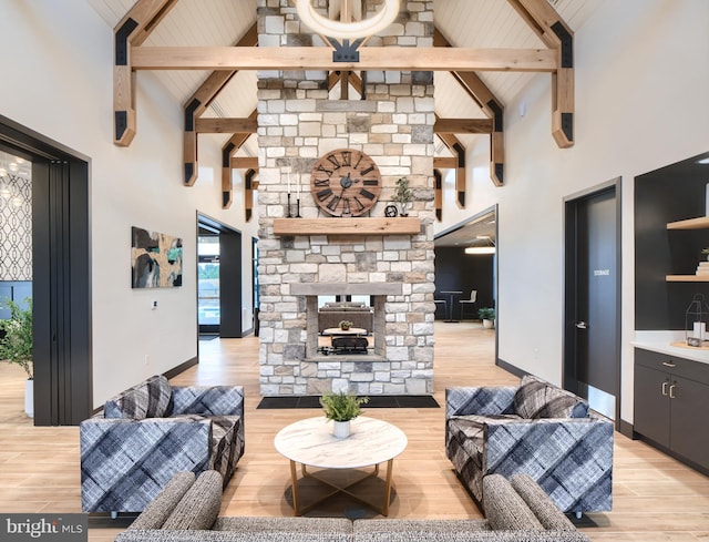 living room with vaulted ceiling with beams, baseboards, and wood finished floors