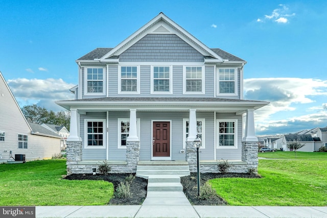 view of front of home with a porch, a front yard, a shingled roof, and central air condition unit