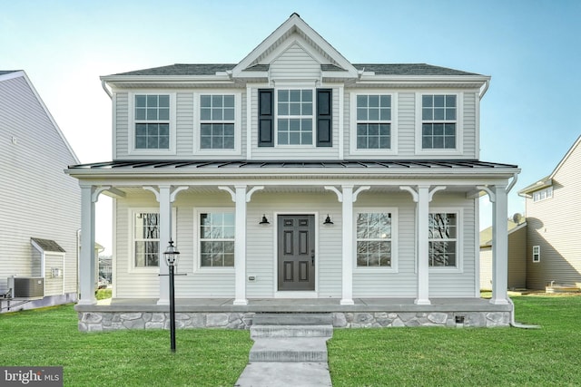 view of front of property with a porch, a standing seam roof, a front lawn, and central air condition unit