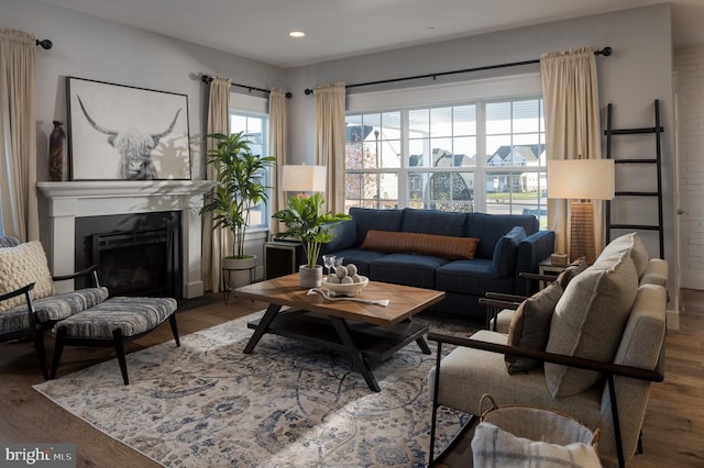 living area with a fireplace, wood finished floors, and recessed lighting