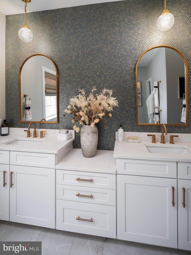 full bath with vanity and marble finish floor