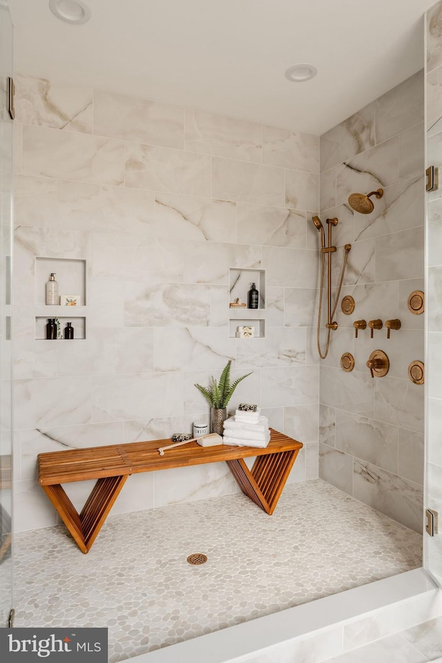bathroom with a tile shower
