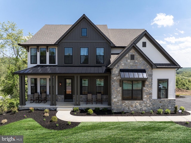 view of front of home with a porch and a front lawn