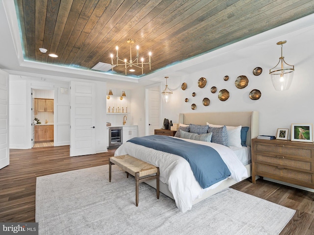 bedroom featuring wood ceiling, a raised ceiling, beverage cooler, connected bathroom, and dark hardwood / wood-style floors