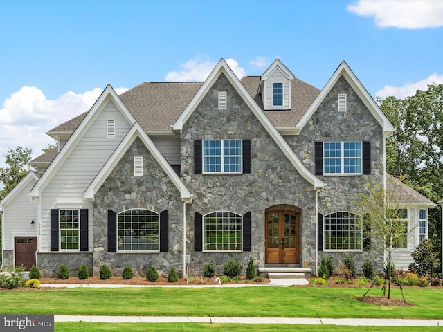 view of front of property with french doors and a front lawn