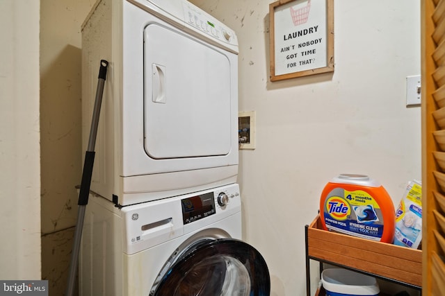 washroom featuring stacked washer / dryer