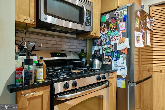 kitchen featuring stainless steel appliances and tasteful backsplash