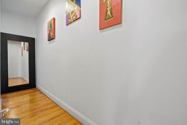 corridor with hardwood / wood-style floors