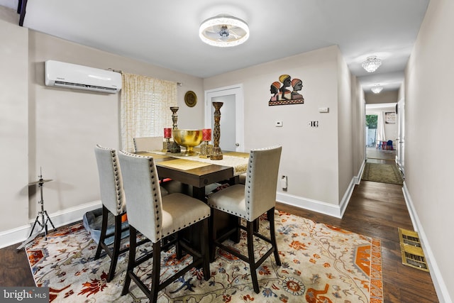 dining area featuring dark hardwood / wood-style flooring and a wall unit AC