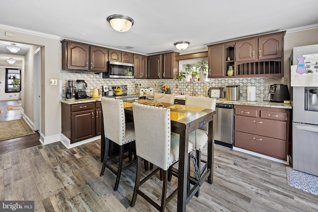 844 Cumberland St, Gloucester City, NJ 08030 - kitchen with decorative backsplash, stainless steel appliances, crown molding, dark brown cabinets, and open shelves