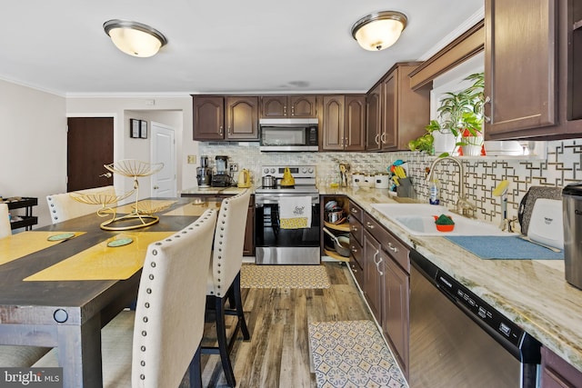 844 Cumberland St, Gloucester City, NJ 08030 - kitchen featuring dark wood finished floors, crown molding, stainless steel appliances, tasteful backsplash, and a sink