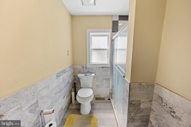844 Cumberland St, Gloucester City, NJ 08030 - full bath featuring toilet, a stall shower, tile walls, and a wainscoted wall
