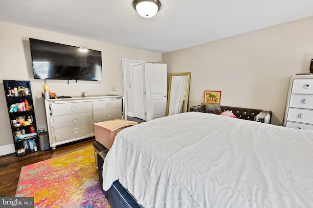 bedroom featuring dark hardwood / wood-style flooring