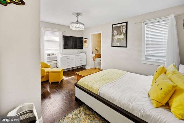 bedroom featuring cooling unit, dark wood-type flooring, a notable chandelier, and multiple windows