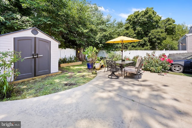 844 Cumberland St, Gloucester City, NJ 08030 - view of patio / terrace with a fenced backyard, a storage unit, an outbuilding, and outdoor dining space
