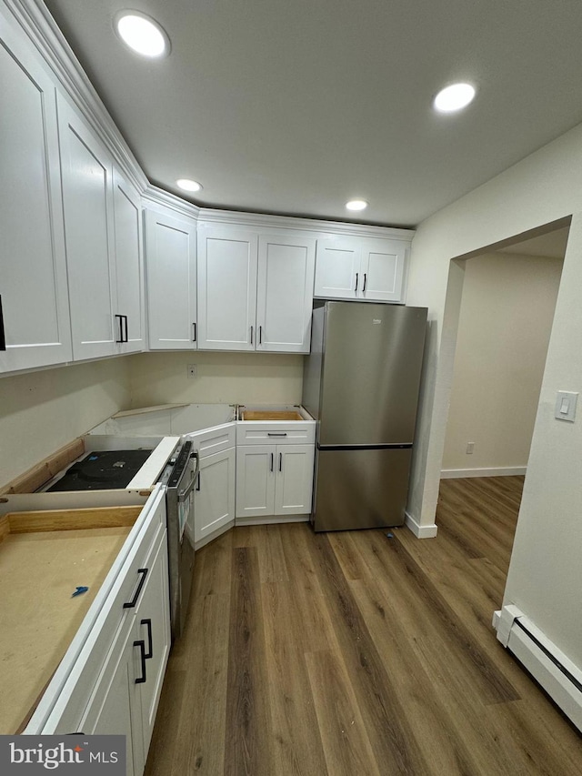 kitchen featuring stainless steel refrigerator, white cabinetry, electric range oven, dark hardwood / wood-style floors, and a baseboard heating unit