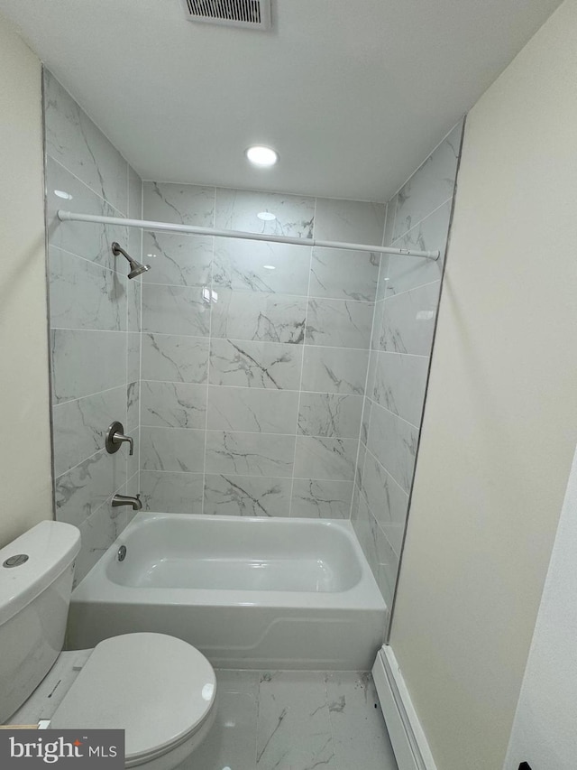 bathroom featuring tiled shower / bath and toilet