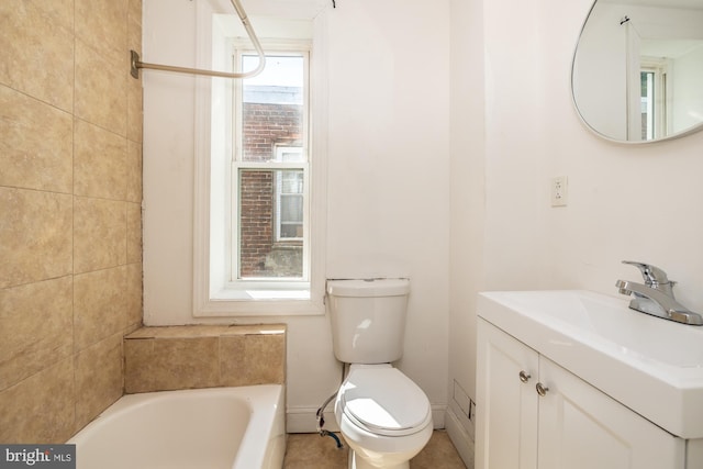 bathroom with vanity, toilet, and a bath