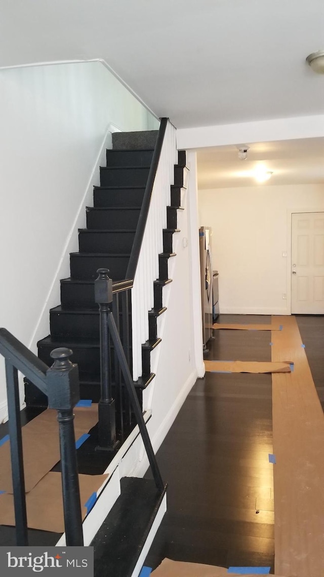 stairway with hardwood / wood-style flooring