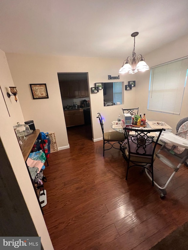 dining room featuring dark hardwood / wood-style floors and an inviting chandelier