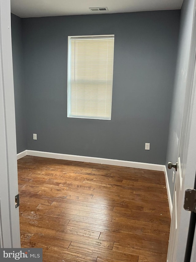 spare room with hardwood / wood-style flooring