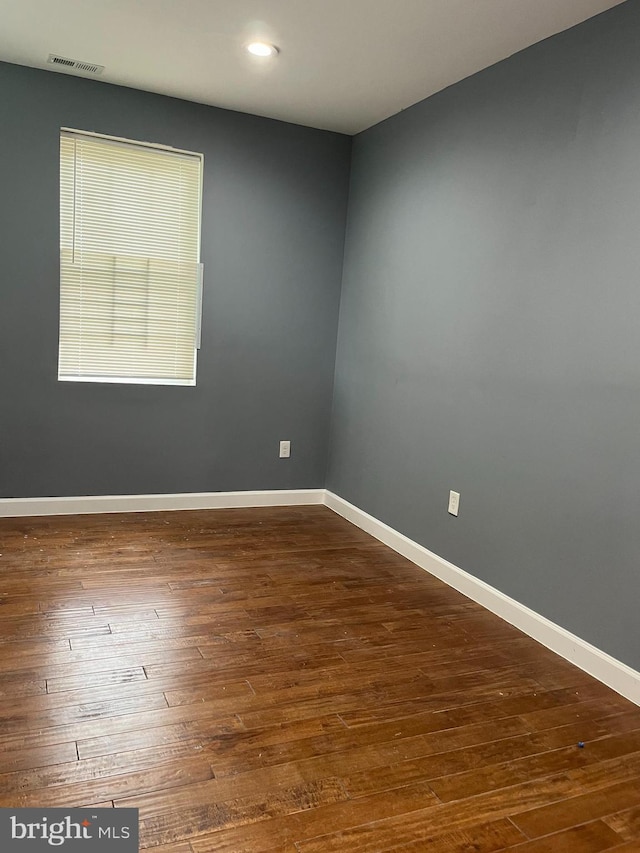 spare room featuring dark hardwood / wood-style flooring