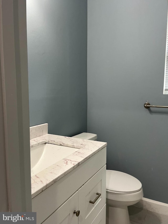 bathroom featuring tile patterned floors, vanity, and toilet