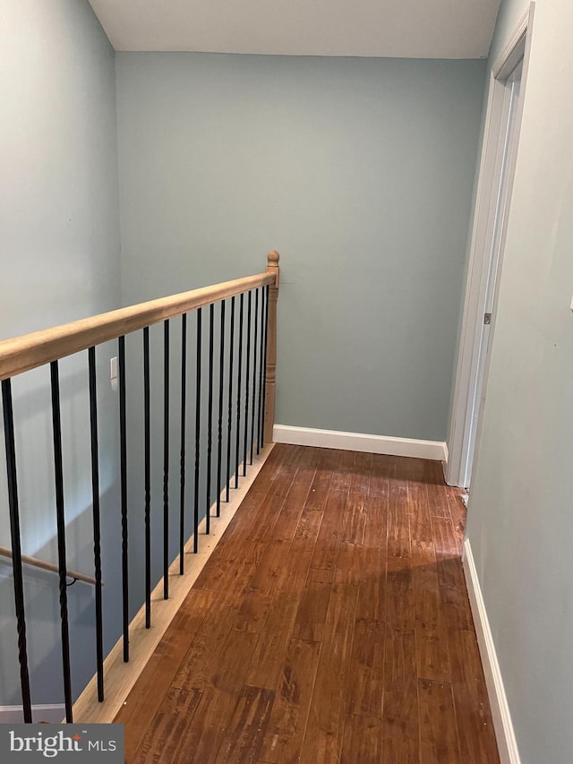 corridor with dark hardwood / wood-style floors