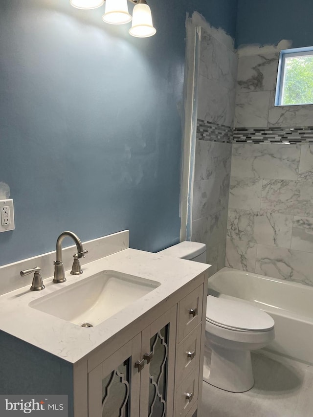 full bathroom featuring vanity, toilet, and tiled shower / bath