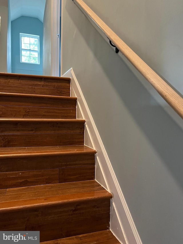 stairs featuring vaulted ceiling