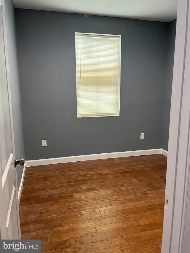 unfurnished room with hardwood / wood-style floors