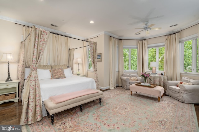 bedroom with recessed lighting, wood finished floors, visible vents, and crown molding