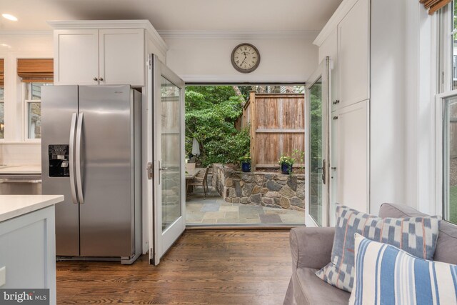 foyer entrance featuring dark hardwood / wood-style floors and ornamental molding