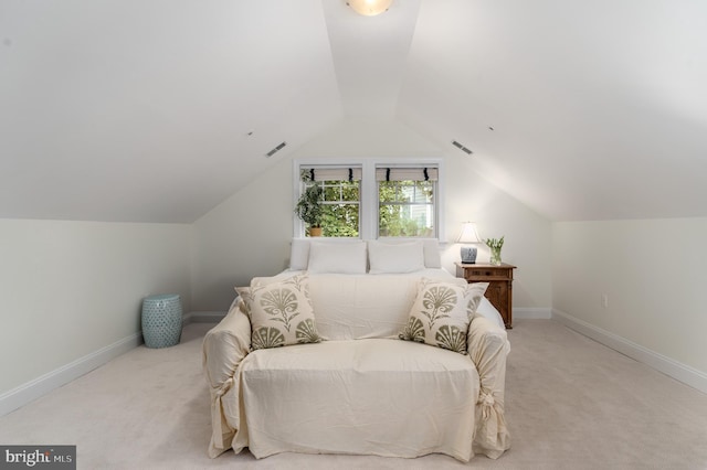 bedroom with visible vents, baseboards, vaulted ceiling, and light colored carpet