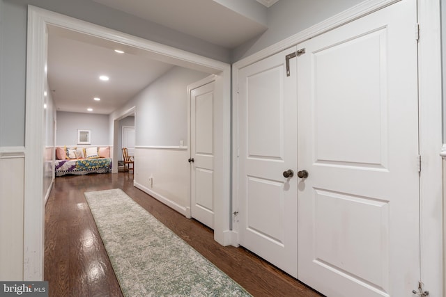 corridor featuring dark wood-type flooring and recessed lighting