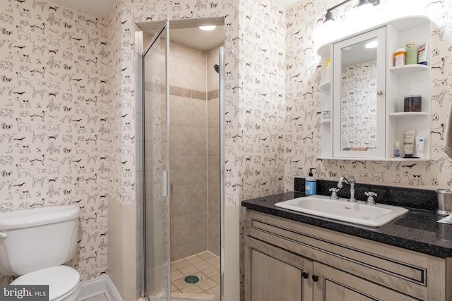 full bathroom featuring vanity, a shower stall, toilet, and wallpapered walls