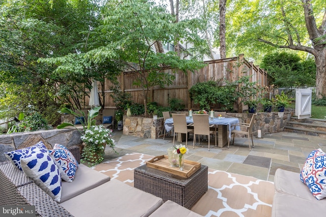 view of patio featuring fence, an outdoor living space, and outdoor dining space