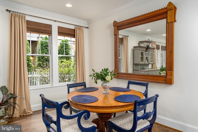 dining room featuring recessed lighting, baseboards, crown molding, and wood finished floors