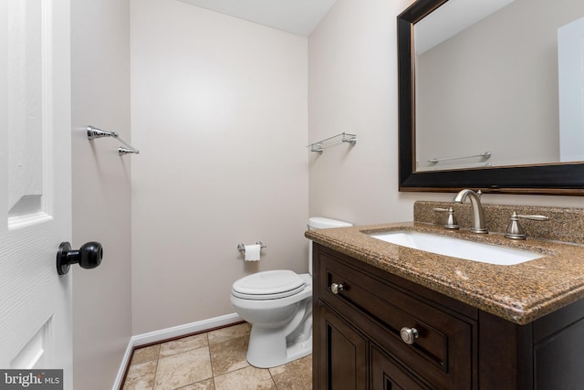 bathroom featuring toilet and vanity