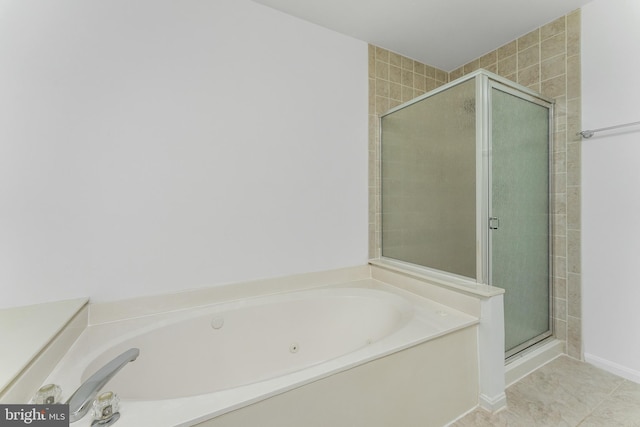 bathroom with separate shower and tub and tile patterned flooring