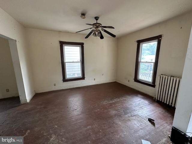 empty room featuring radiator and ceiling fan