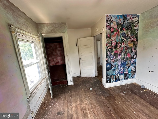 unfurnished bedroom with dark wood-type flooring