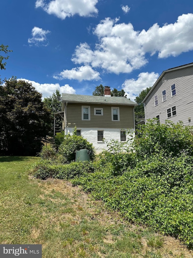 back of property featuring a yard