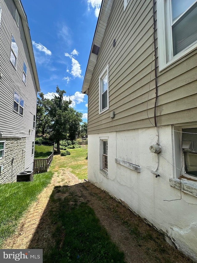 view of side of property with a yard