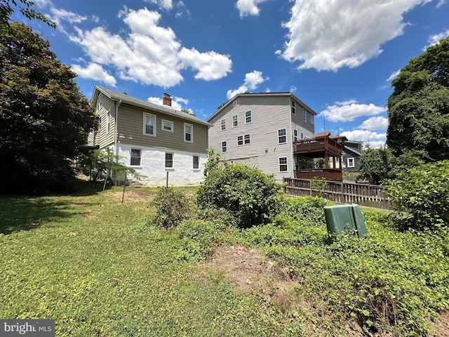 rear view of house featuring a yard