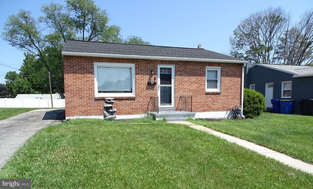 bungalow-style home with a front lawn