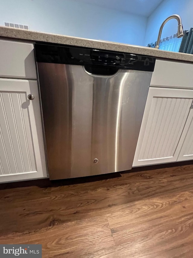 interior details featuring white cabinetry, dishwasher, and sink