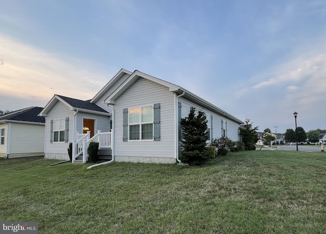 view of front of house with a yard